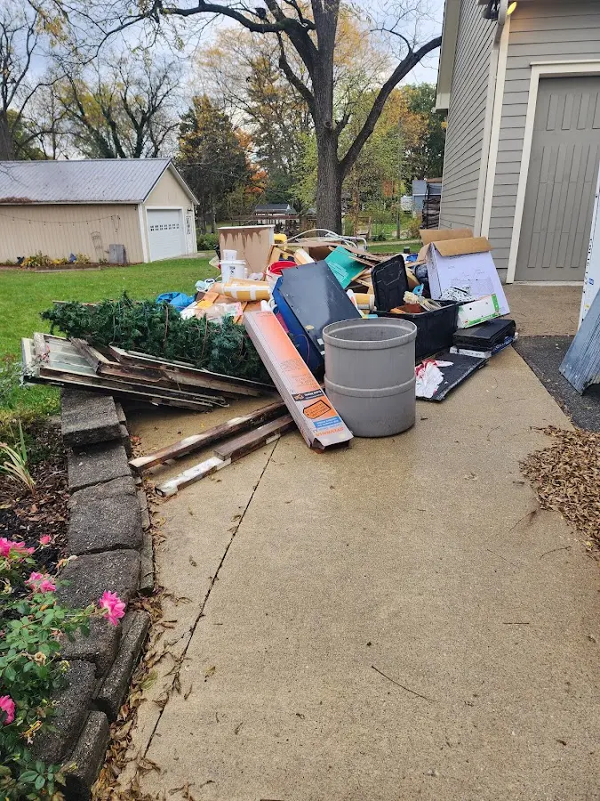 Dumpster being loaded with debris for Residential Dumpster Rental in Rock Valley